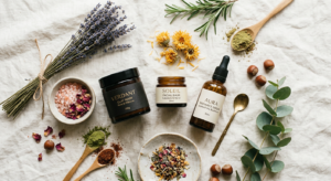 A refined, editorial-style flat lay featuring organic skincare jars, raw botanical ingredients, and